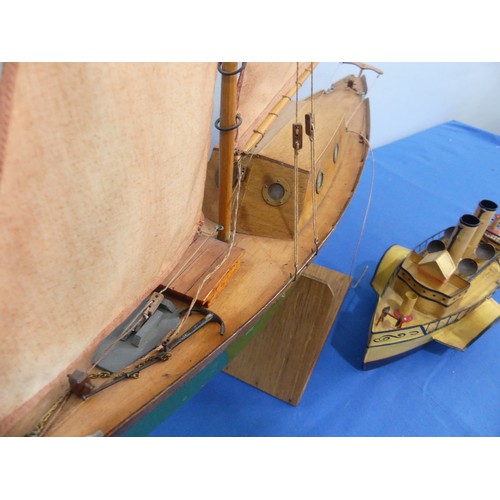 435 - A wooden model sailing yacht, with mask, sails, anchor, wooden rudder cabin with windows, painted gr... 