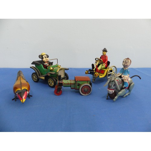 441 - A tinplate clockwork donkey with rider, made in Japan with GR trademark, with key and in working ord... 