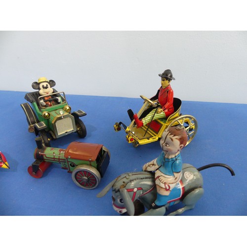 441 - A tinplate clockwork donkey with rider, made in Japan with GR trademark, with key and in working ord... 