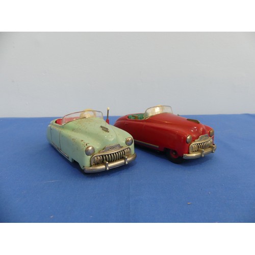 442 - Two Schuco tinplate clockwork vehicles, comprising a red radio 4012 musical car, in good condition, ... 