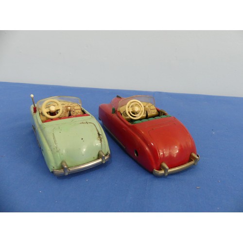 442 - Two Schuco tinplate clockwork vehicles, comprising a red radio 4012 musical car, in good condition, ... 