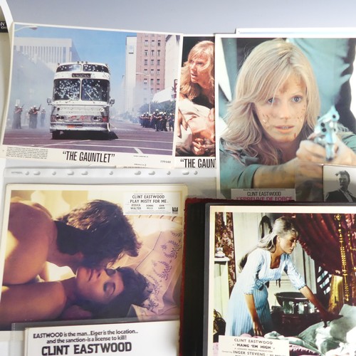 76 - A quantity of Clint Eastwood movie Lobby Cards, including ; an album with taped down sets consisting... 