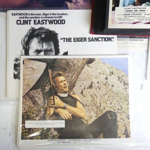 76 - A quantity of Clint Eastwood movie Lobby Cards, including ; an album with taped down sets consisting... 