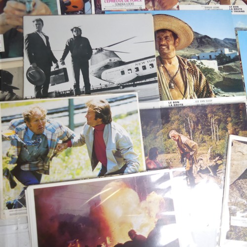 76 - A quantity of Clint Eastwood movie Lobby Cards, including ; an album with taped down sets consisting... 