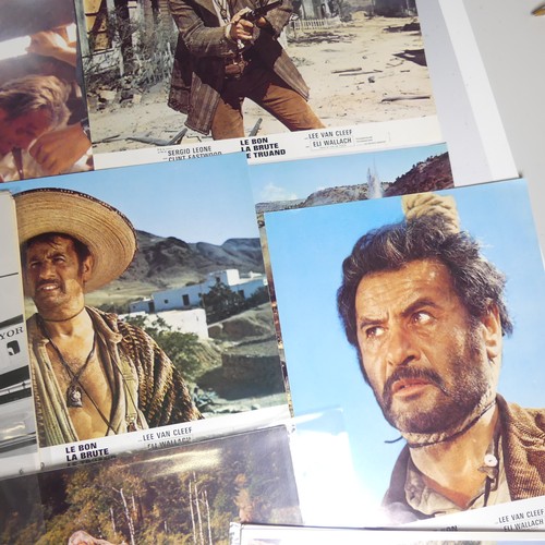 76 - A quantity of Clint Eastwood movie Lobby Cards, including ; an album with taped down sets consisting... 