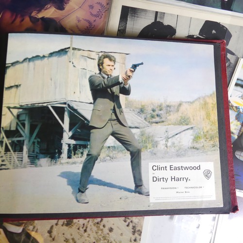 76 - A quantity of Clint Eastwood movie Lobby Cards, including ; an album with taped down sets consisting... 