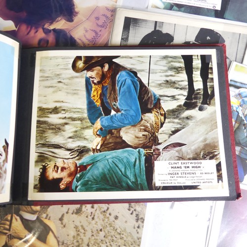 76 - A quantity of Clint Eastwood movie Lobby Cards, including ; an album with taped down sets consisting... 