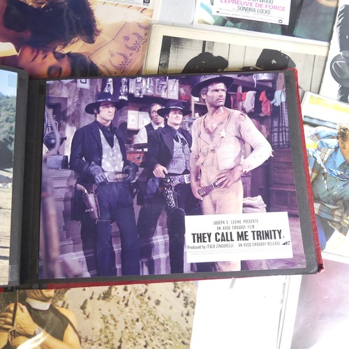 76 - A quantity of Clint Eastwood movie Lobby Cards, including ; an album with taped down sets consisting... 