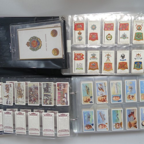 73 - Cigarette Cards: four albums of cigarette cards, mainly 'military' issues, including Wills' Allied A... 