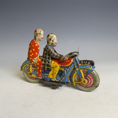 A rare British tinplate clockwork motorcycle featuring two clowns, possibly by Marx, registration number OU2, fuel tank stamped 'Made in Great Britain', the whole printed in 'circus' colours, overall good condition, clockwork mechanism in working order, L 21.5cm.