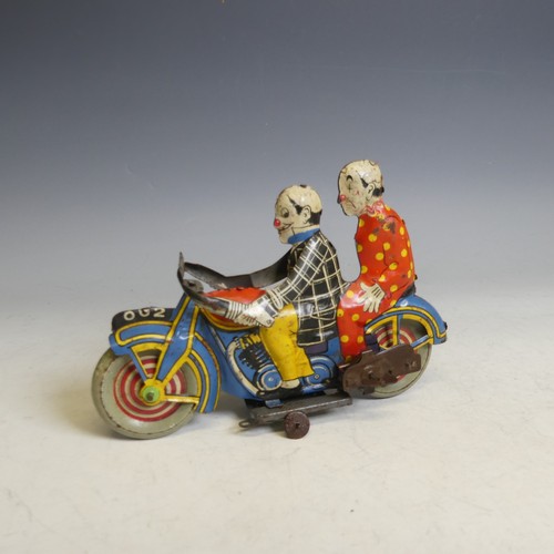 467 - A rare British tinplate clockwork motorcycle featuring two clowns, possibly by Marx, registration nu... 