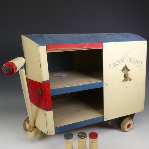 430 - A vintage painted wood Royal Dairy pull-along Milk Cart, including wooden milk bottles, together wit... 