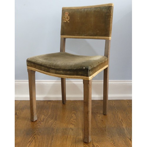 A George VI 1937 Coronation chair, in limed oak with original faded velvet upholstery, with GR monogram, officially stamped and also stamped with maker's mark 'North & Sons, West Wycombe' on underside of chair.