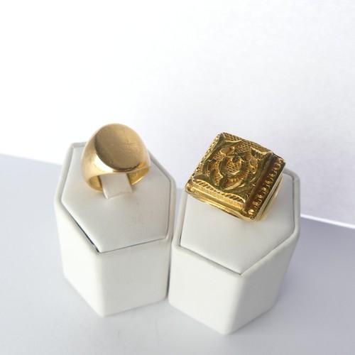 452 - An unmarked gold Signet Ring, with plain oval front, Size M, tests as 18ct, together with a circular... 