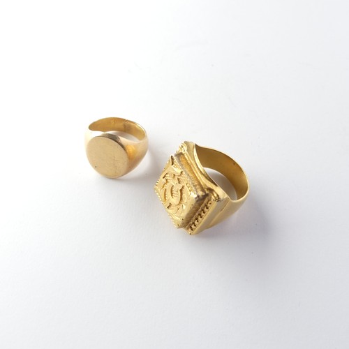 452 - An unmarked gold Signet Ring, with plain oval front, Size M, tests as 18ct, together with a circular... 