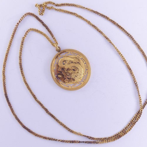 453 - A Chinese circular gold Pendant Medallion, the front with dragon chasing the pearl, the reverse with... 