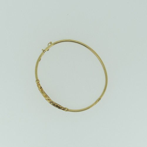 388 - A 9ct gold hollow hinged Bangle, the cross over front set white pastes, approx total weight 7.6g.... 