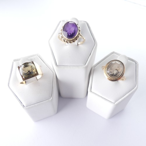 281 - A 9ct gold smoky quartz Ring, with ropetwist border, Size N, together with an amethyst ring, Size O ... 