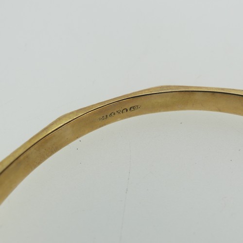 394 - A 9ct gold Bangle, dodecagon with engraved edges, 7.3cm internal diameter, 14.1g.