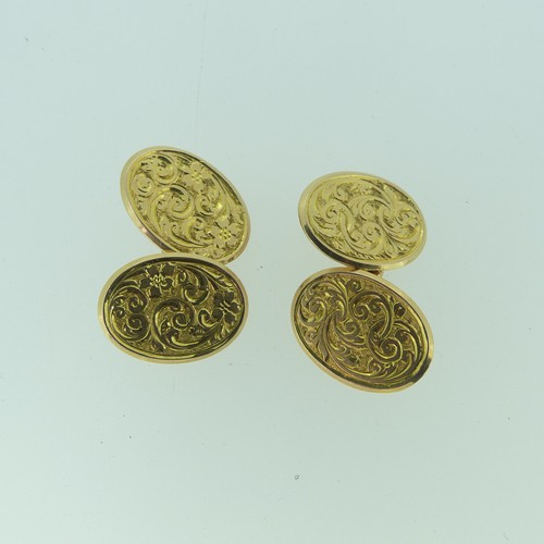 469 - A pair of 15ct gold oval Cufflinks, both sides with foliate engraved decoration, 9.5g.... 