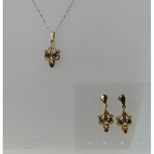 480 - A 9ct gold and garnet Pendant and Earring suite, the pendant 2.5cm long, approx total weight 4.2g.... 