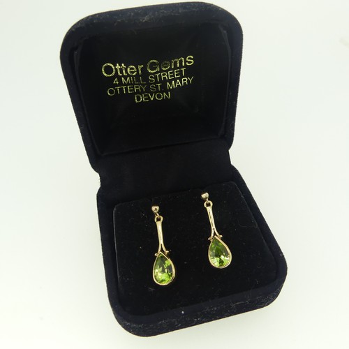 422 - A pair of 9ct gold Peridot Earrings, formed of pear shaped drops, the stones approx 8.6mm long, stud... 