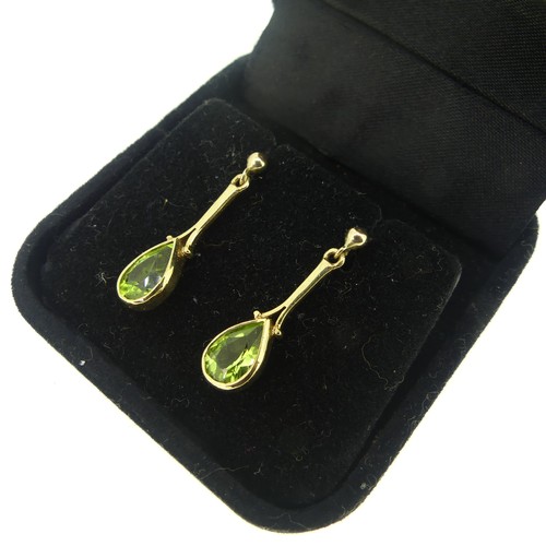 422 - A pair of 9ct gold Peridot Earrings, formed of pear shaped drops, the stones approx 8.6mm long, stud... 