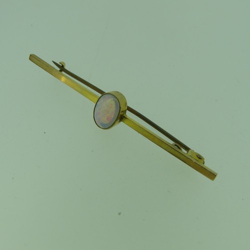 423 - An opal Bar Brooch, the oval stone approx 8.4mm, millegrain set in the centre of the plain 9ct gold ... 