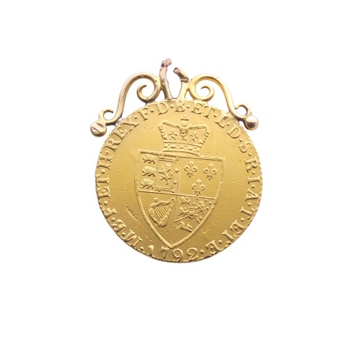 726 - A George III gold Guinea, dated 1792, with soldered mount, total weight 9.1g.