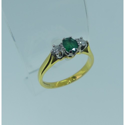 294 - An emerald and diamond three stone Ring, the oval emerald approx. 5.1x3.9mm, with a circular diamond... 