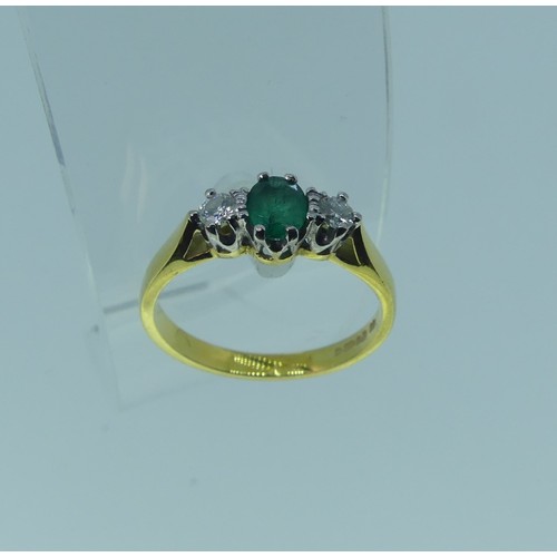 294 - An emerald and diamond three stone Ring, the oval emerald approx. 5.1x3.9mm, with a circular diamond... 