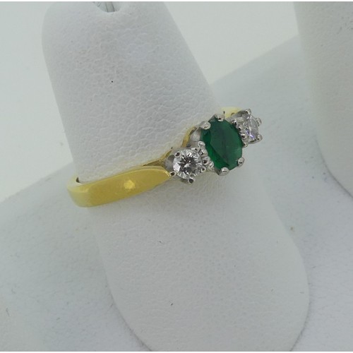 294 - An emerald and diamond three stone Ring, the oval emerald approx. 5.1x3.9mm, with a circular diamond... 