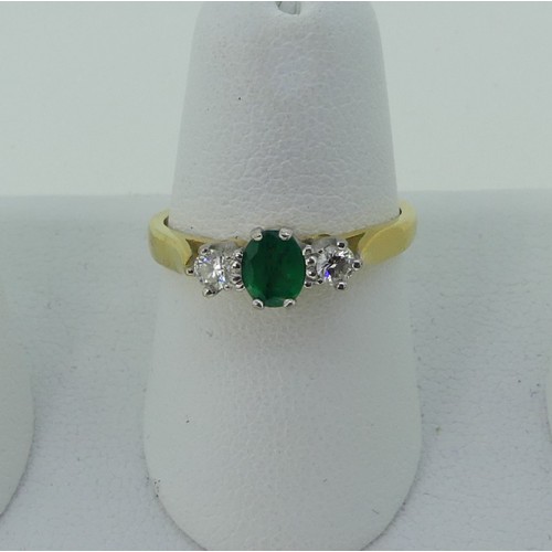 294 - An emerald and diamond three stone Ring, the oval emerald approx. 5.1x3.9mm, with a circular diamond... 