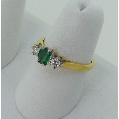 294 - An emerald and diamond three stone Ring, the oval emerald approx. 5.1x3.9mm, with a circular diamond... 