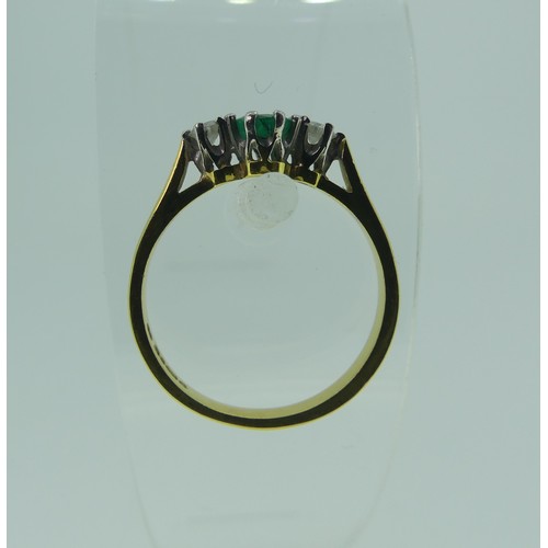 294 - An emerald and diamond three stone Ring, the oval emerald approx. 5.1x3.9mm, with a circular diamond... 