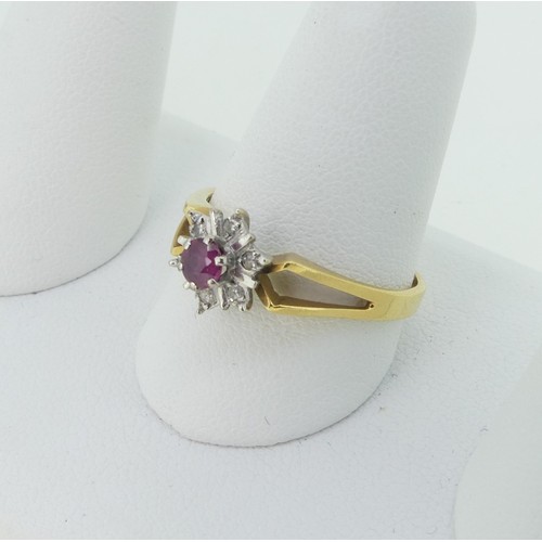 299 - A small ruby and diamond cluster Ring, mounted in 18ct yellow and white gold with split shoulders, S... 