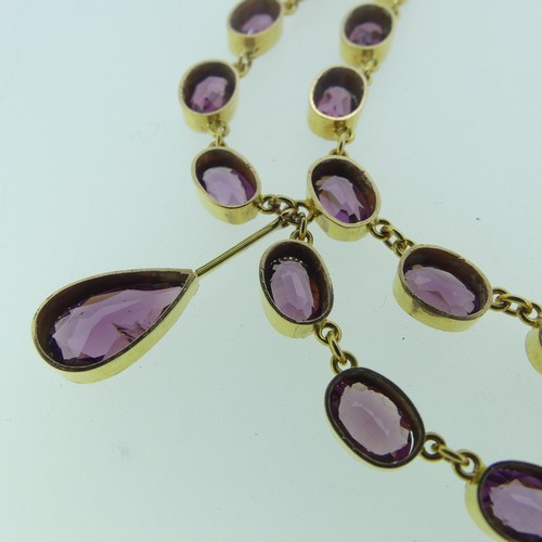 363 - An almandine garnet festoon Necklace, formed of two looped rows of oval facetted garnets, each appro... 