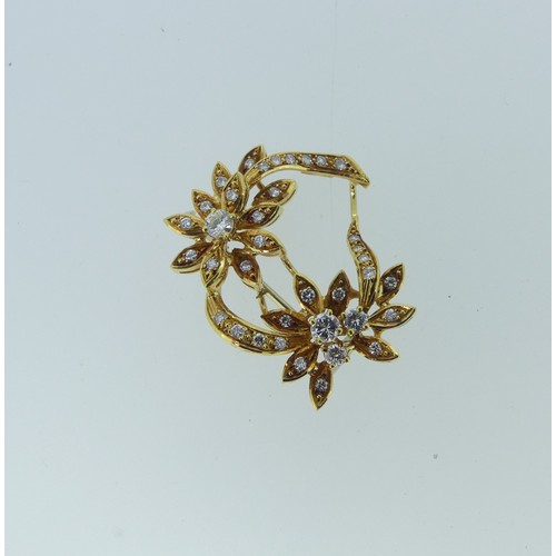 425 - An 18ct yellow gold and diamond foliate Brooch, the two principle diamonds each approx. 0.14ct, with... 