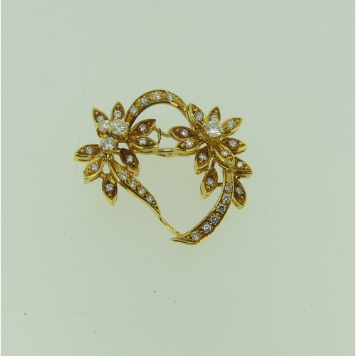 425 - An 18ct yellow gold and diamond foliate Brooch, the two principle diamonds each approx. 0.14ct, with... 