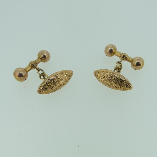 483 - A pair of 9ct rose gold hollow Cufflinks, the navette shaped fronts with foliate decoration, bar rev... 