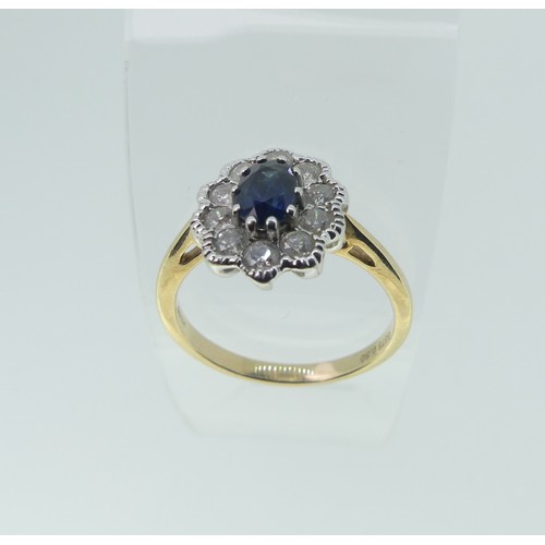 307 - A sapphire and diamond cluster Ring, the central oval facetted sapphire approx. 5.6x4.1mm, surrounde... 