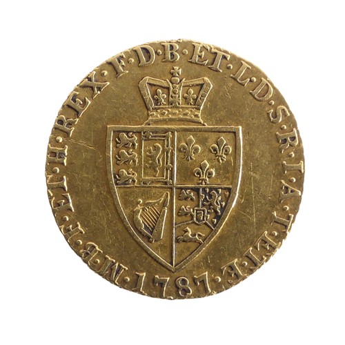 606 - A George III gold Half Guinea, dated 1787, the reverse with spade shaped coat of arms.Provenance; Th... 