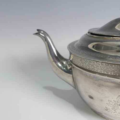 124 - A George III silver Teapot, hallmarked London, 1805, of oval form with bright cut decoration, wooden... 