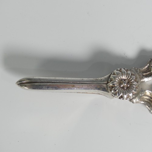 129 - A pair of Elizabeth II silver Grape Scissors, by Charles S Green & Co Ltd., hallmarked Birmingha... 