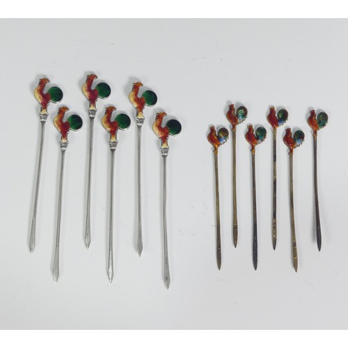 130 - A set of six Art Deco silver Cocktail Sticks, each with enamelled cockerel finials, marked 'Silver',... 