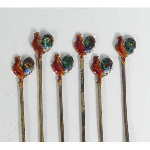 130 - A set of six Art Deco silver Cocktail Sticks, each with enamelled cockerel finials, marked 'Silver',... 