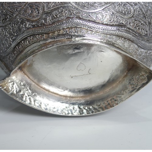 136 - A pair of antique Indian silver boat-shaped Dishes, with bird head handles, pierced rims and chased ... 