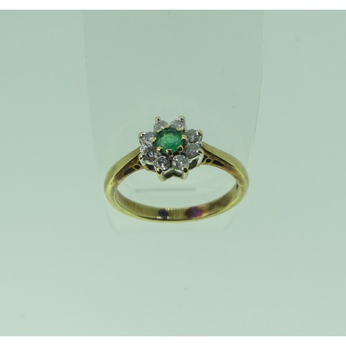 331 - An emerald and diamond cluster Ring, the central circular emerald approx. 3.85mm diameter surrounded... 