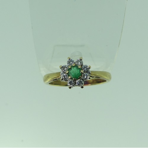 331 - An emerald and diamond cluster Ring, the central circular emerald approx. 3.85mm diameter surrounded... 