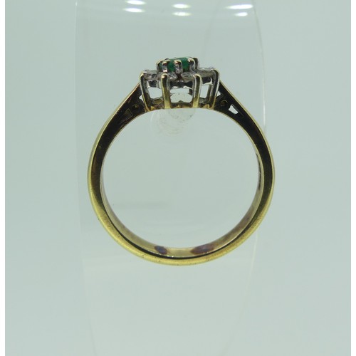 331 - An emerald and diamond cluster Ring, the central circular emerald approx. 3.85mm diameter surrounded... 